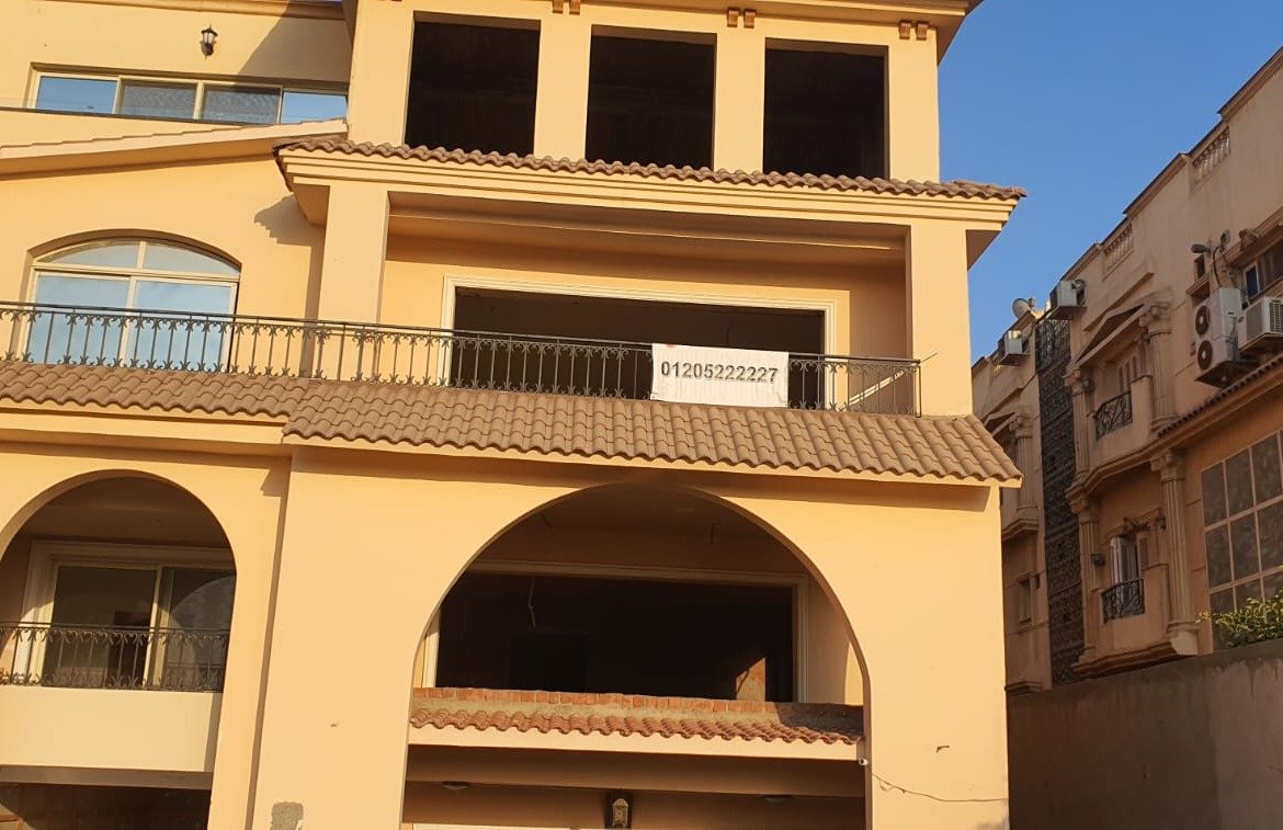 Yellow villa with arched windows and a balcony - apartment in Gharb Golf 5th Settlement