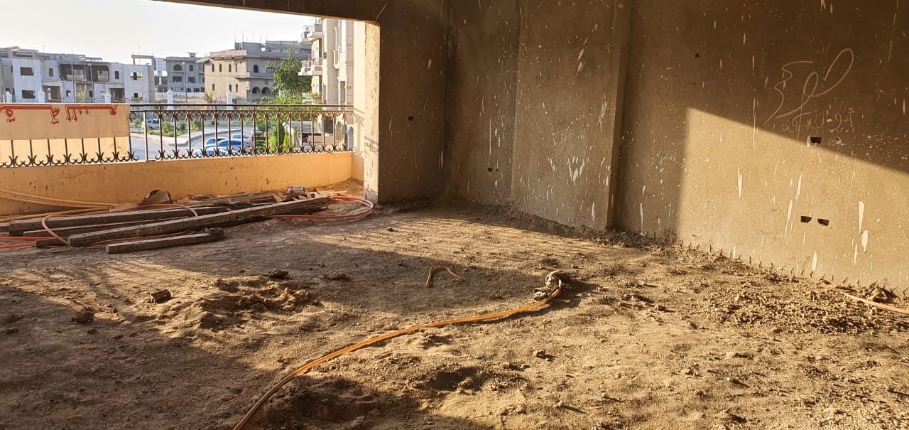 gharb-golf-apt-260-06 Bare room with a wide opening and a sandy floor in sunlight - apartment in Gharb Golf 5th Settlement