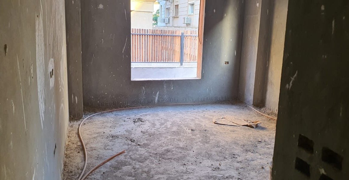 Unfinished room with a single window and cable conduits on the floor - apartment in Gharb Golf 5th Settlement