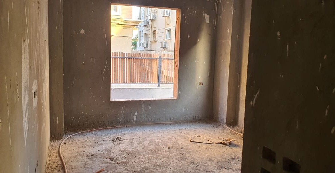Unfinished room with a window facing a wooden fence - apartment in Gharb Golf 5th Settlement