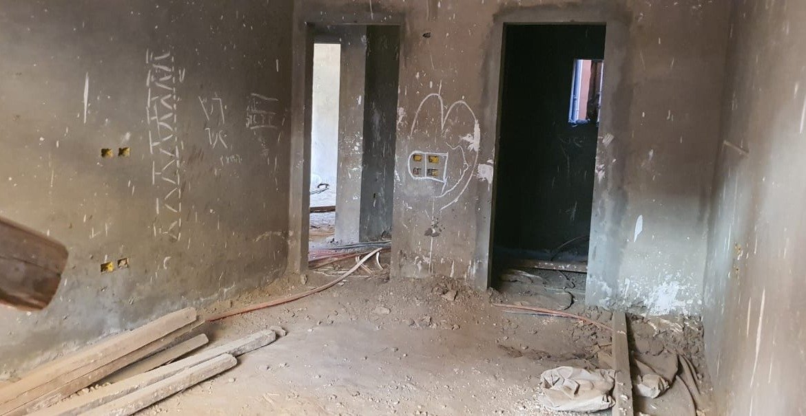 Rough unfinished room with two doorways and building debris - apartment in Gharb Golf 5th Settlement