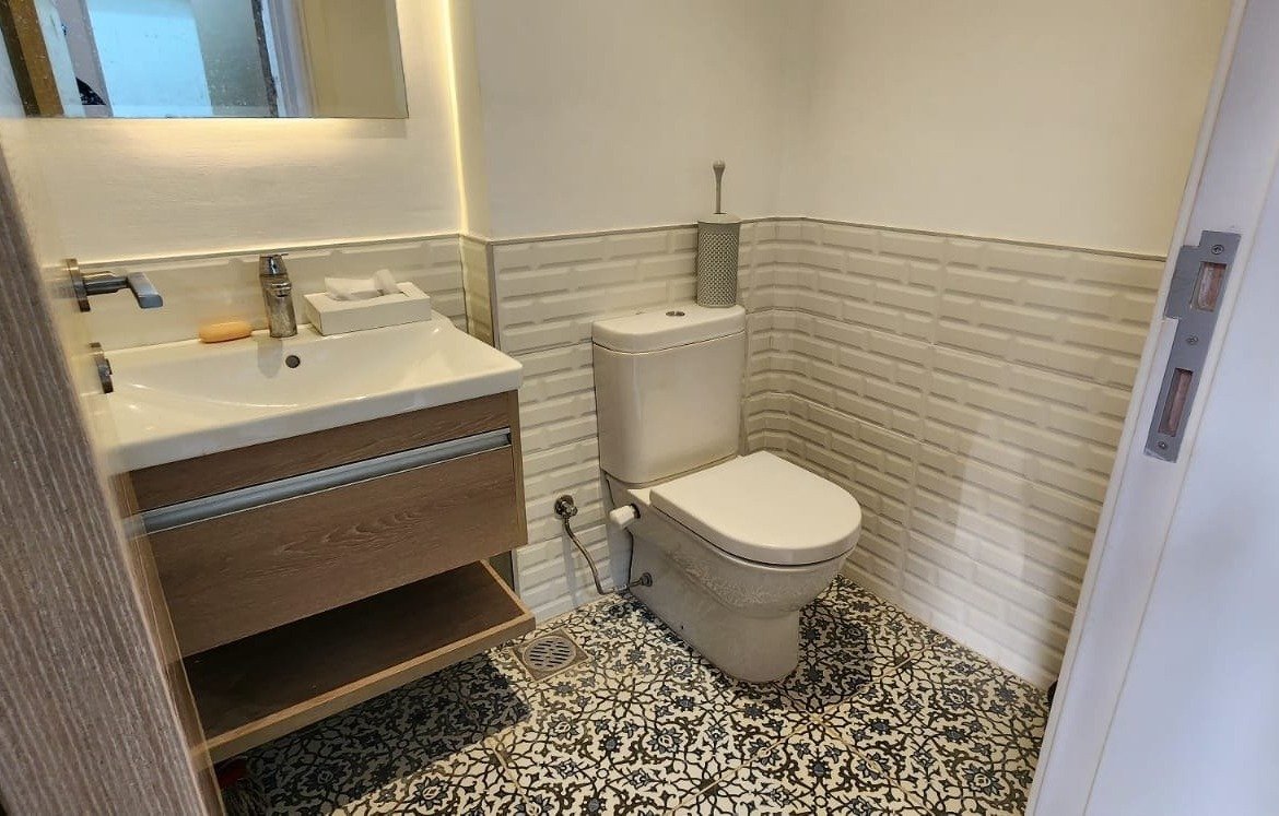 Bathroom with patterned tile floor and floating basin - townhouse in Marassi, North Coast
