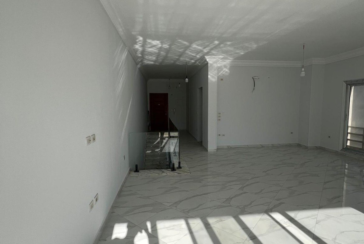 Empty room with floor shadows - duplex in Hyde Park, New Cairo