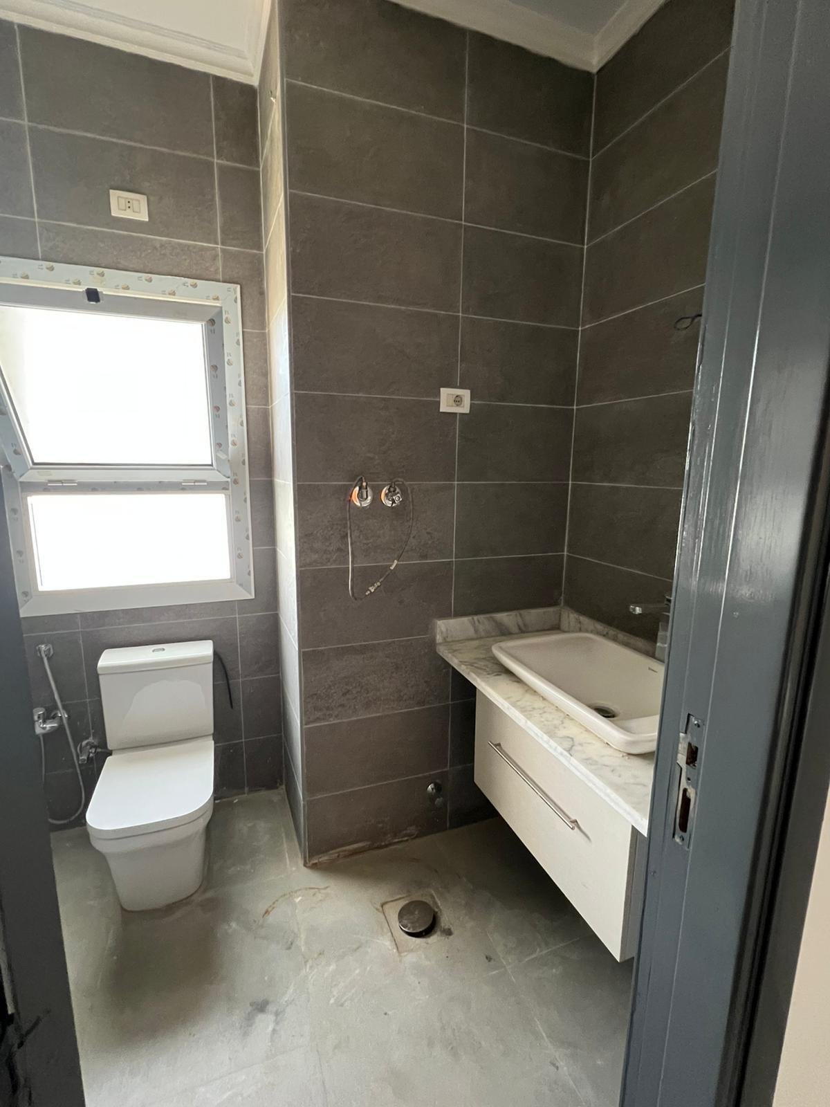 Bathroom with vanity and window - duplex in Hyde Park, New Cairo