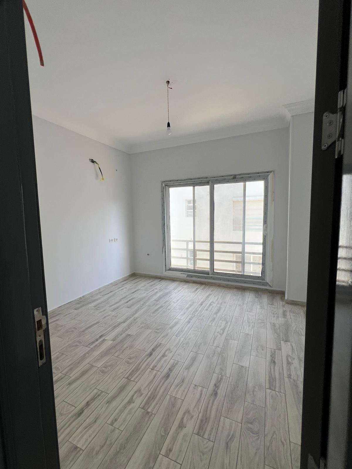 Empty bedroom with balcony window - duplex in Hyde Park, New Cairo