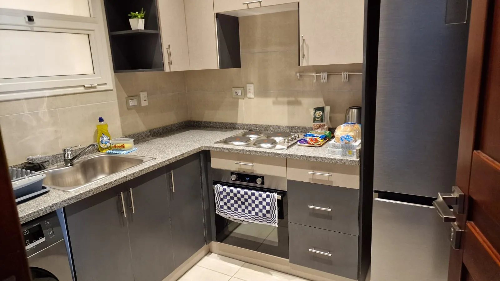 Kitchen with grey cabinets and appliances - studio in Hyde Park, New Cairo