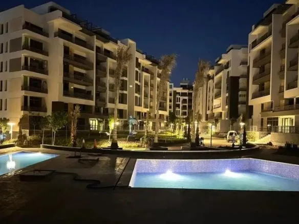The Icon Gardens New Cairo swimming pool night view - apartment for sale