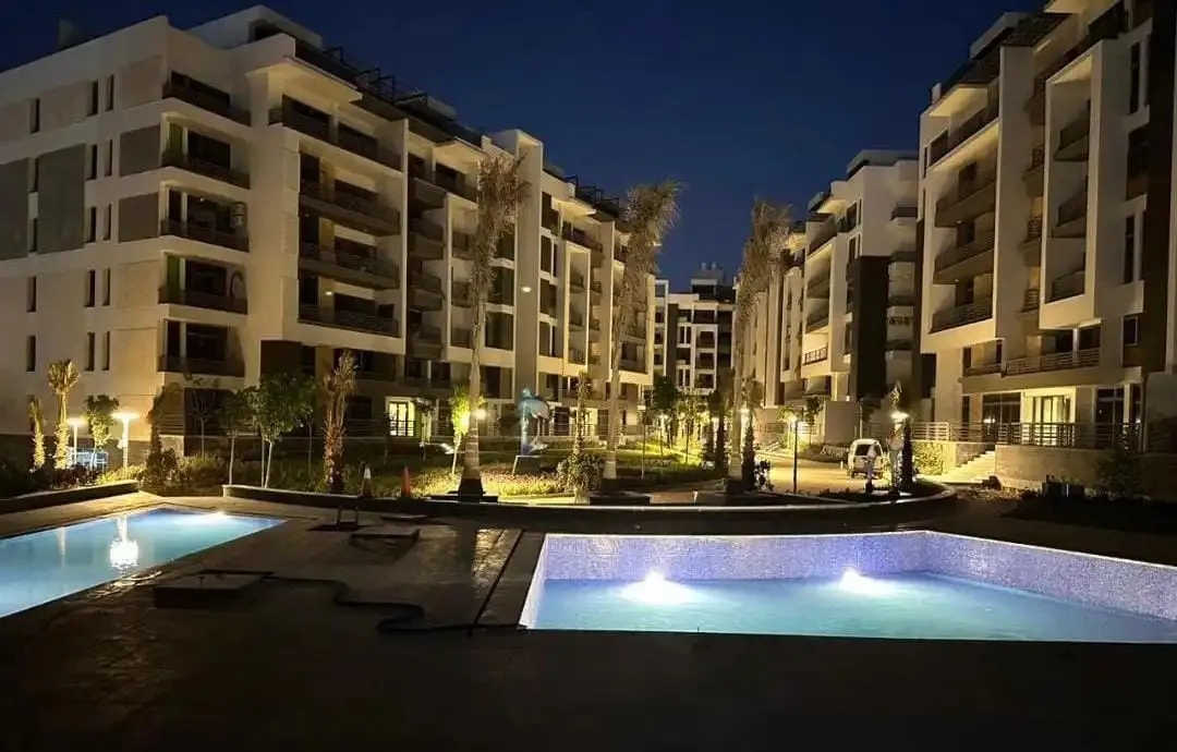 The Icon Gardens New Cairo swimming pool night view - apartment for sale