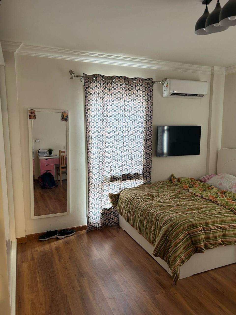 Bedroom with a wall TV, wall AC and wood floor - duplex in Jayd New Cairo – 3 Bedrooms 260 sqm with Private Garden, New Cairo