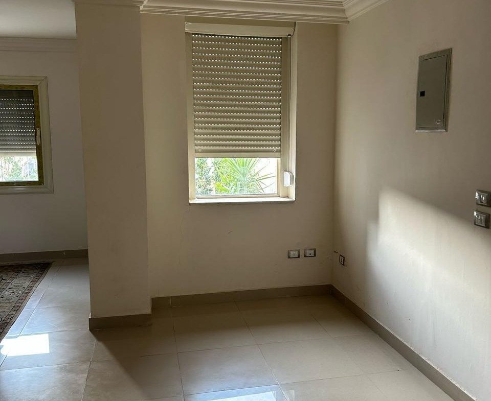 Empty room with polished tiles and a rolling shutter window - duplex in Jayd New Cairo – 3 Bedrooms 260 sqm with Private Garden, New Cairo
