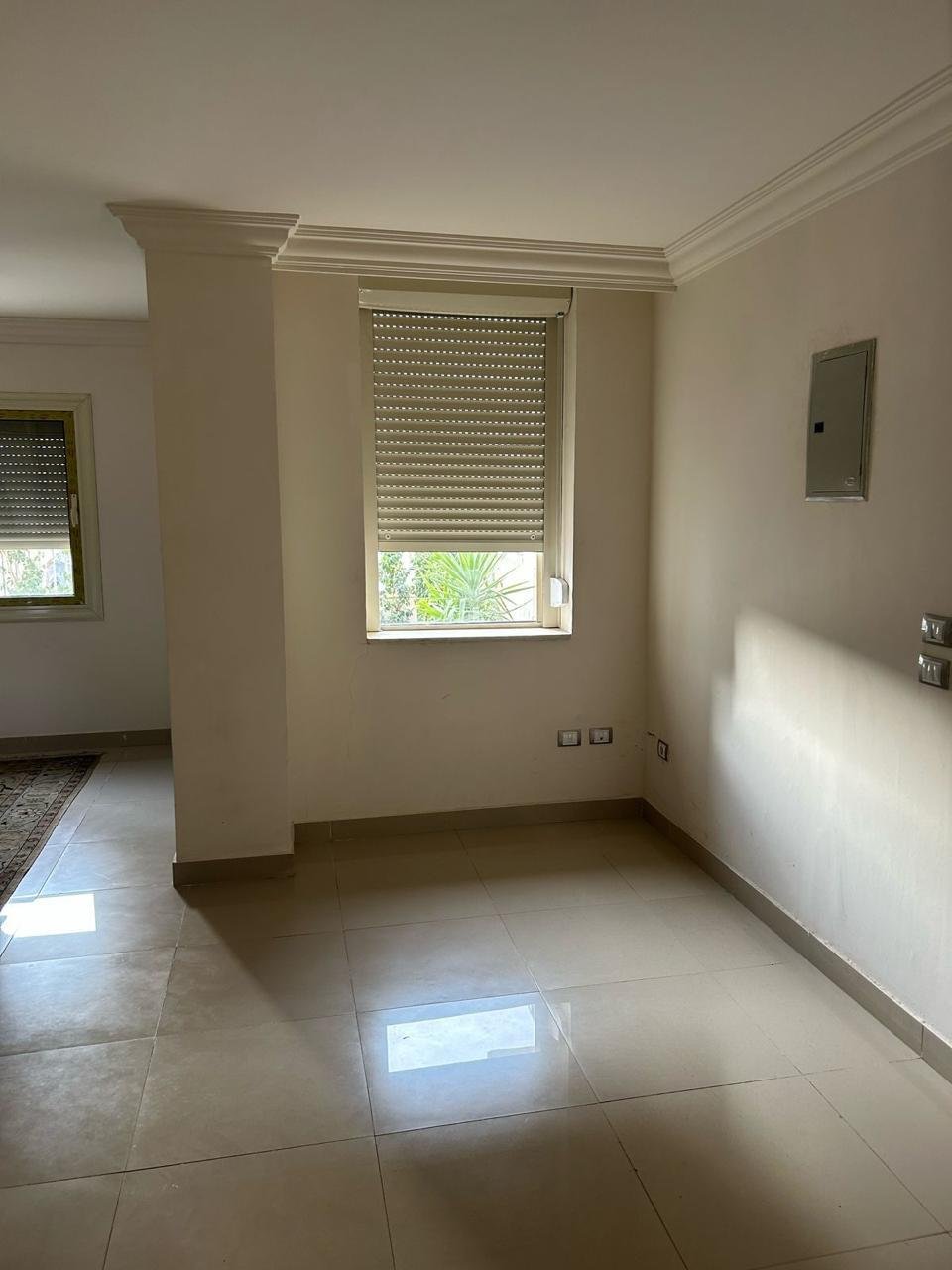 Empty room with polished tiles and a rolling shutter window - duplex in Jayd New Cairo – 3 Bedrooms 260 sqm with Private Garden, New Cairo