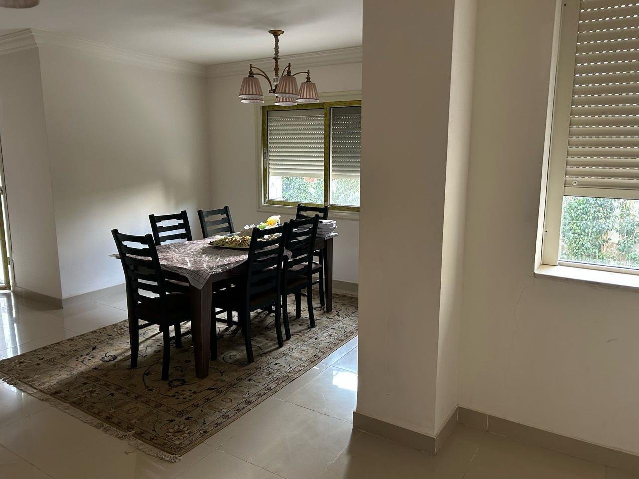 Dining table with black chairs under a chandelier - duplex in Jayd New Cairo – 3 Bedrooms 260 sqm with Private Garden, New Cairo