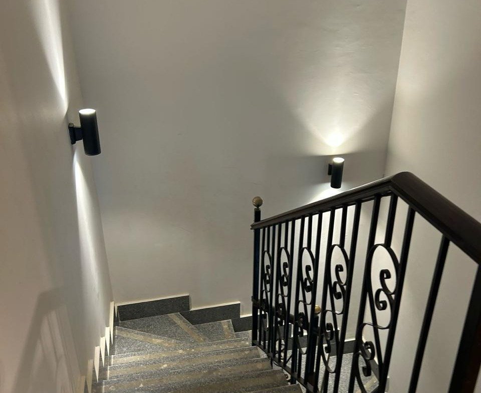 Staircase with a wrought-iron railing and wall lights - duplex in Jayd New Cairo – 3 Bedrooms 260 sqm with Private Garden, New Cairo