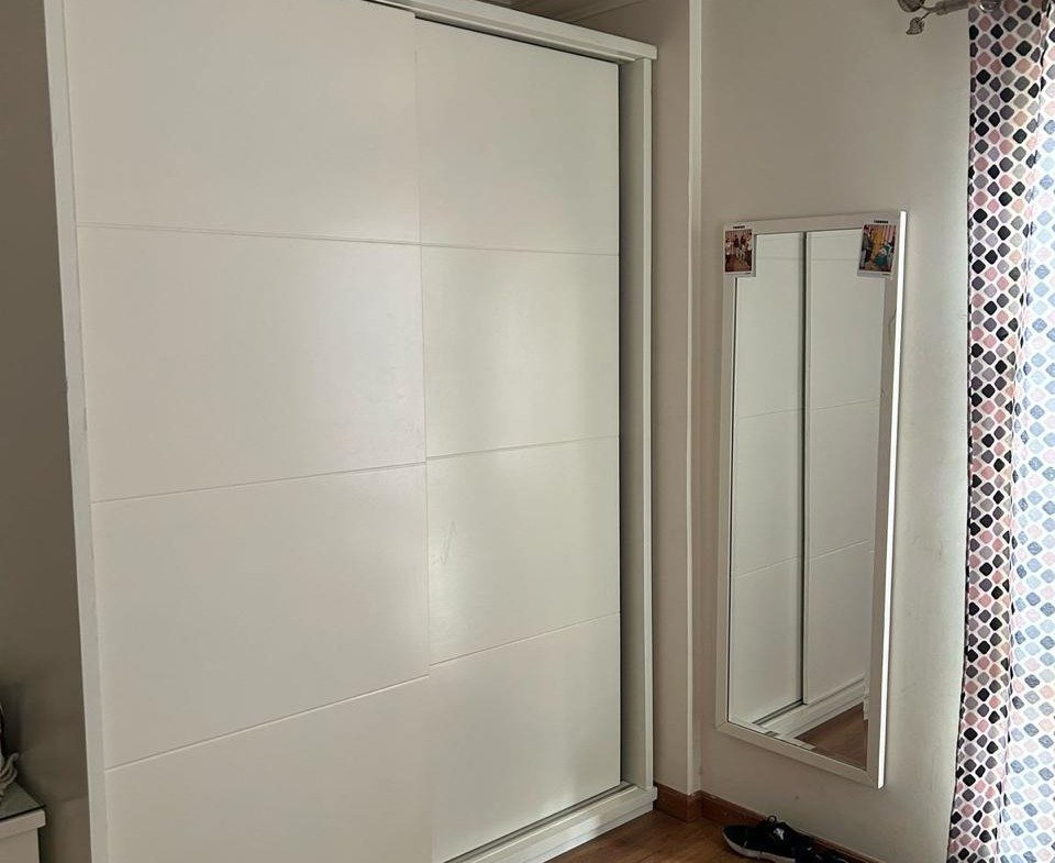 White sliding-door wardrobe with a mirror and wood floor - duplex in Jayd New Cairo – 3 Bedrooms 260 sqm with Private Garden, New Cairo