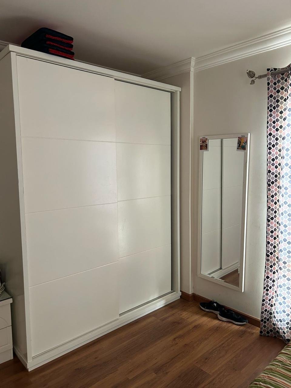 White sliding-door wardrobe with a mirror and wood floor - duplex in Jayd New Cairo – 3 Bedrooms 260 sqm with Private Garden, New Cairo