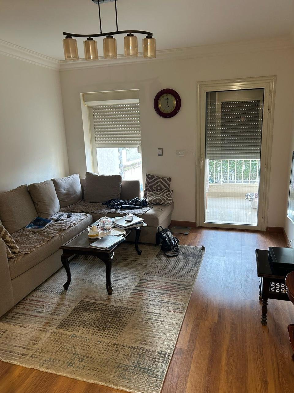 Living room with a grey sofa and a coffee table on parquet flooring - duplex in Jayd New Cairo – 3 Bedrooms 260 sqm with Private Garden, New Cairo