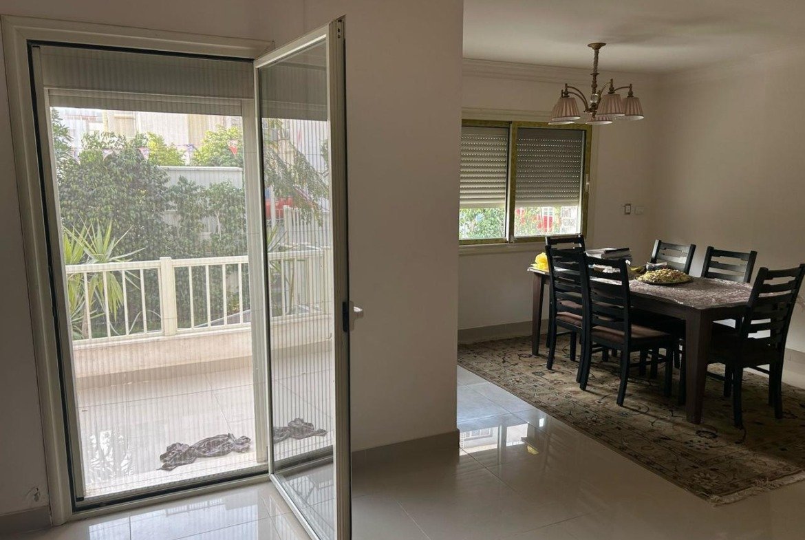 Dining area and open balcony door onto a garden terrace - duplex in Jayd New Cairo – 3 Bedrooms 260 sqm with Private Garden, New Cairo