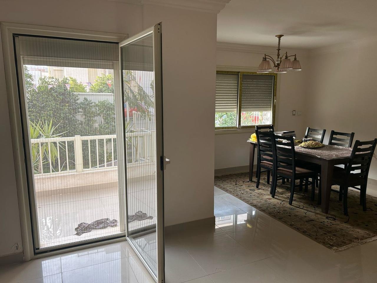 Dining area and open balcony door onto a garden terrace - duplex in Jayd New Cairo – 3 Bedrooms 260 sqm with Private Garden, New Cairo
