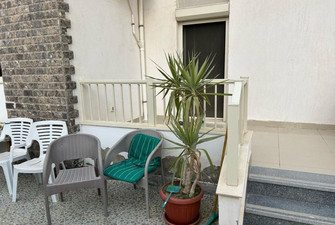 Garden terrace seating with a palm plant and steps - duplex in Jayd New Cairo – 3 Bedrooms 260 sqm with Private Garden, New Cairo