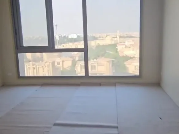 Empty room with a wide window in JW Marriott, New Cairo