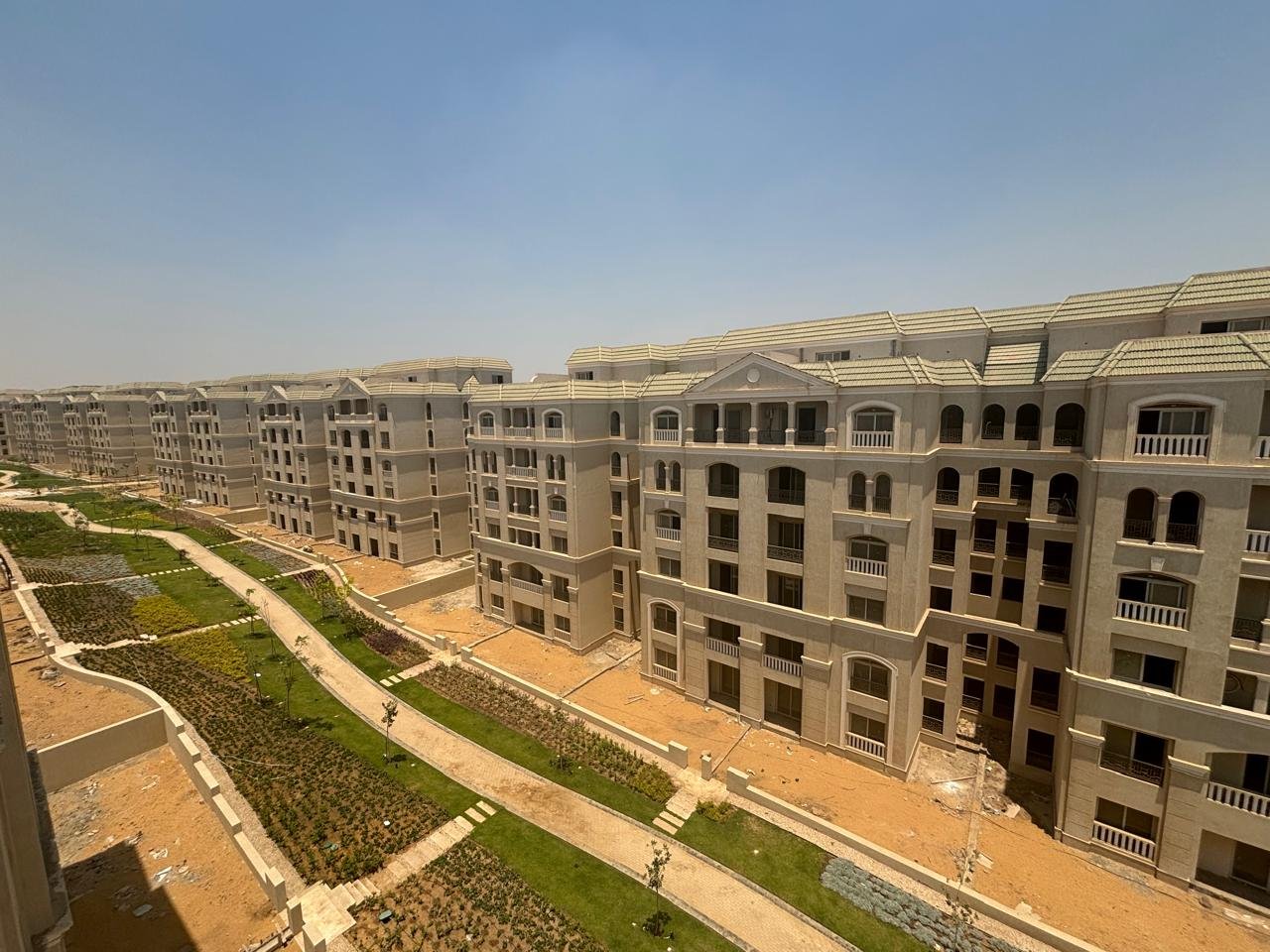 lav524-u10 Long row of apartment blocks with planted slopes and a paved walkway - apartment in L’avenir Sabbour, Mostaqbal City