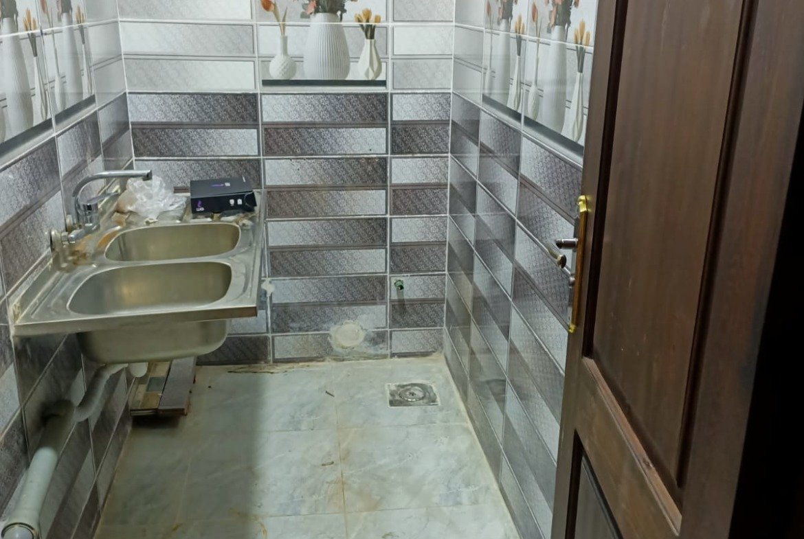 Service room with a sink and tiled wall - apartment in South Lotus on South 90th Street, New Cairo