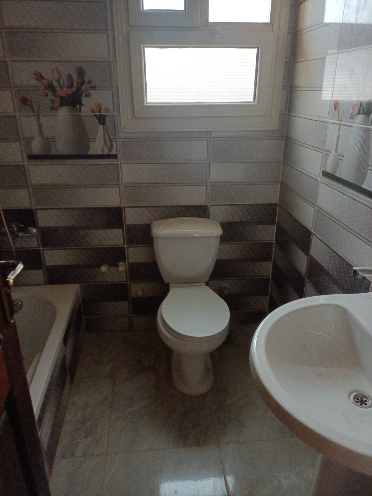 lotus-south-apt-223-ph11 Bathroom with a toilet and a washbasin under a small window - apartment in South Lotus on South 90th Street, New Cairo
