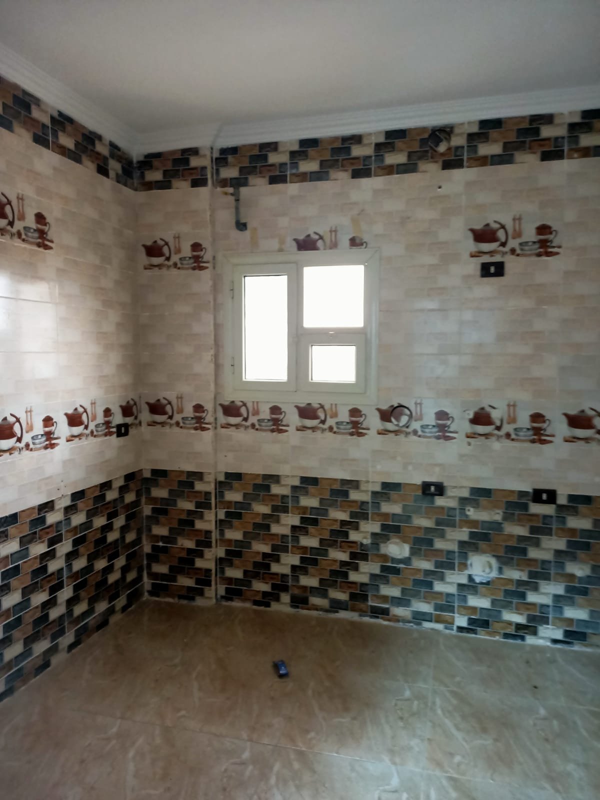 lotus-south-apt-223-ph4 Empty bathroom with flower-border tiles and a small window - apartment in South Lotus on South 90th Street, New Cairo