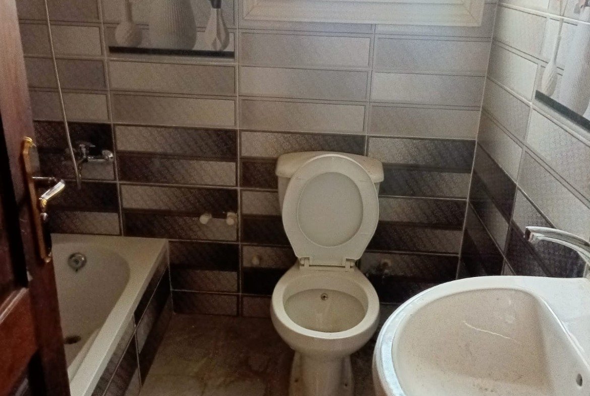 Bathroom with a toilet, basin and tub - apartment in South Lotus on South 90th Street, New Cairo