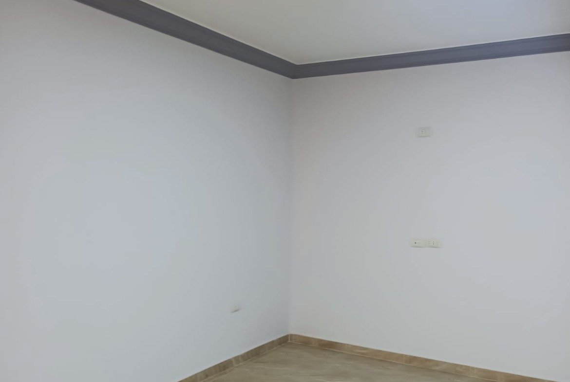 Empty room corner with plain walls and brown floor tiles - apartment in South Lotus on South 90th Street, New Cairo