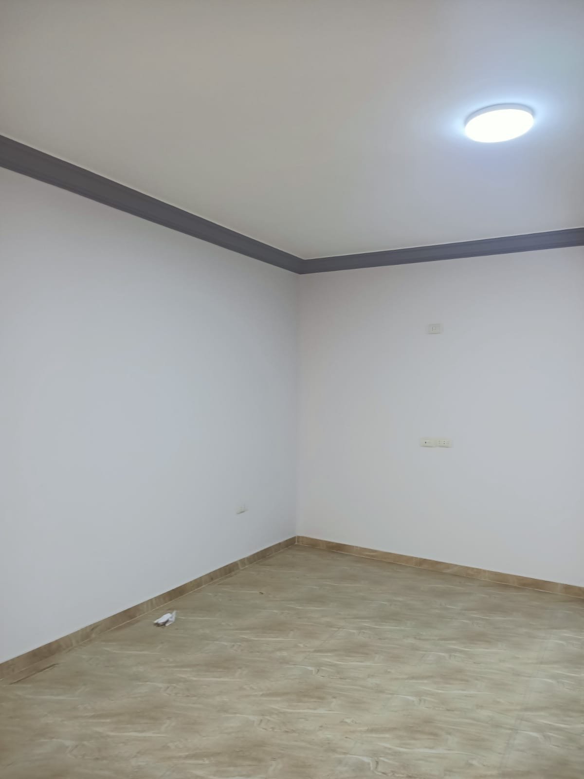 lotus-south-apt-223-ph7 Empty room corner with plain walls and brown floor tiles - apartment in South Lotus on South 90th Street, New Cairo