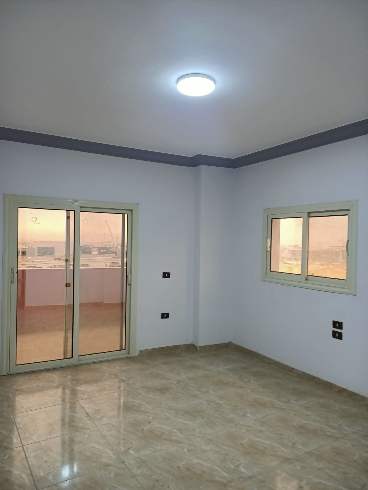 lotus-south-apt-223-ph8 Empty room with a balcony door and a window - apartment in South Lotus on South 90th Street, New Cairo