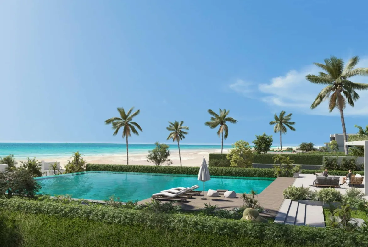 Pool and beach with palms in front of white buildings - unit in LVLS Ras El Hekma, North Coast