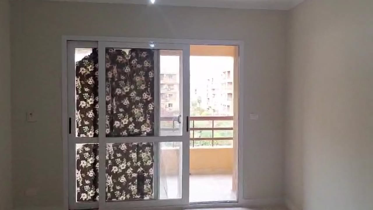 Sliding balcony door with a floral privacy film - apartment in Madinaty – 3 Bedrooms 105 sqm Garden View Catch Price, New Cairo
