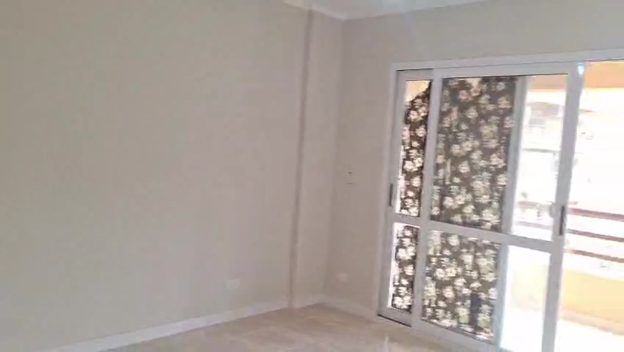 Corner of an empty room beside the balcony door - apartment in Madinaty – 3 Bedrooms 105 sqm Garden View Catch Price, New Cairo
