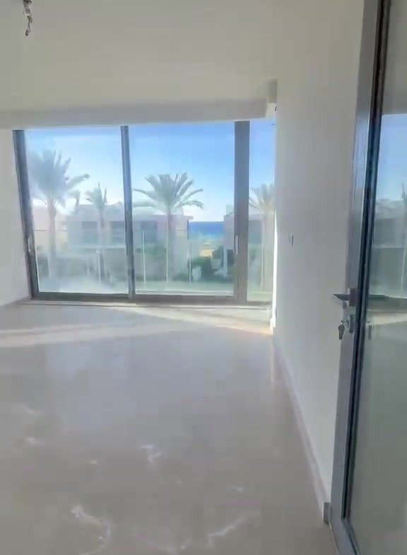 Empty room with large glass wall and sea view - villa in Marassi Bay, North Coast