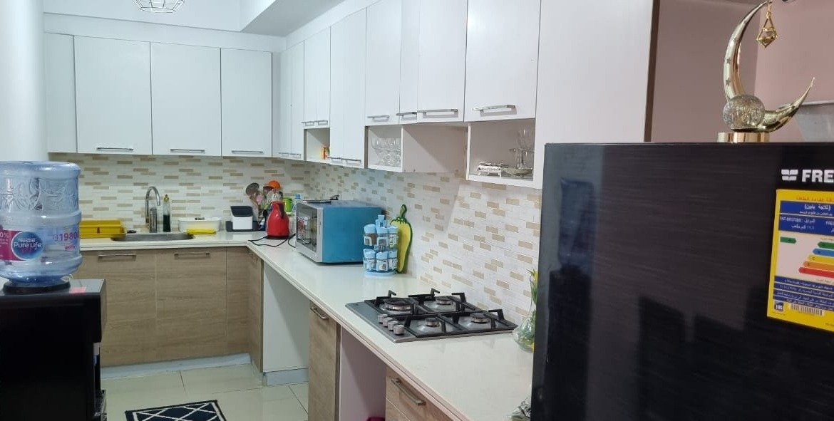 Kitchen with white cabinets and gas hob - chalet in Marassi Marina 1, North Coast