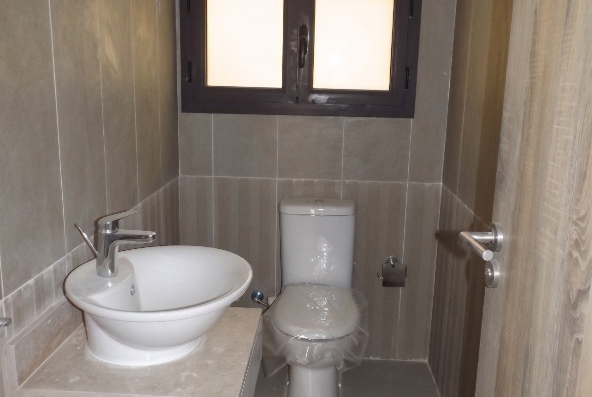 Bathroom with round washbasin and toilet - apartment in Moon Residence, Fifth Square, New Cairo