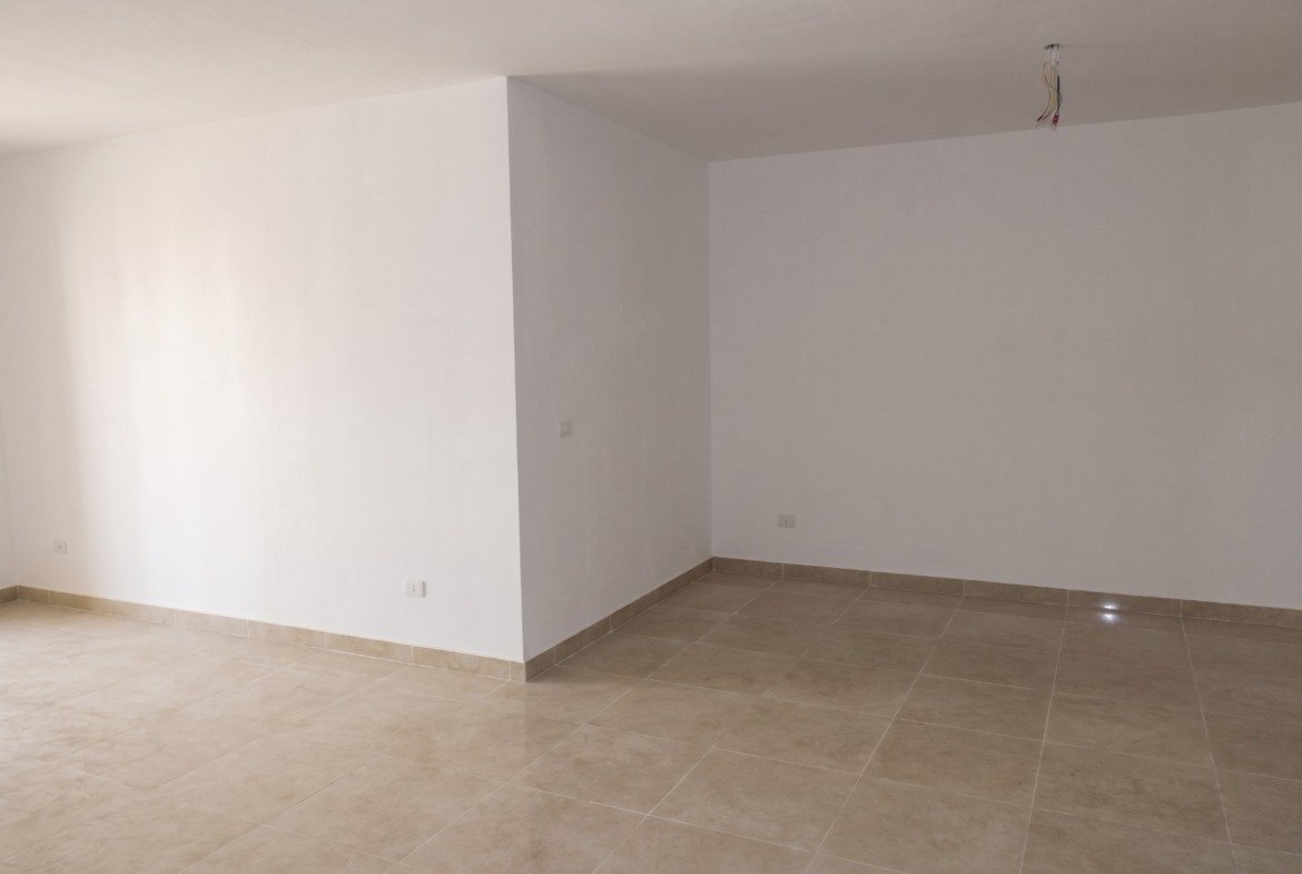 Empty living room with tiled floor - apartment in Moon Residence, Fifth Square, New Cairo