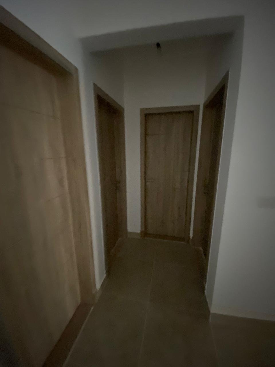 Hallway with wooden doors - apartment in Moon Residence, Fifth Square, New Cairo