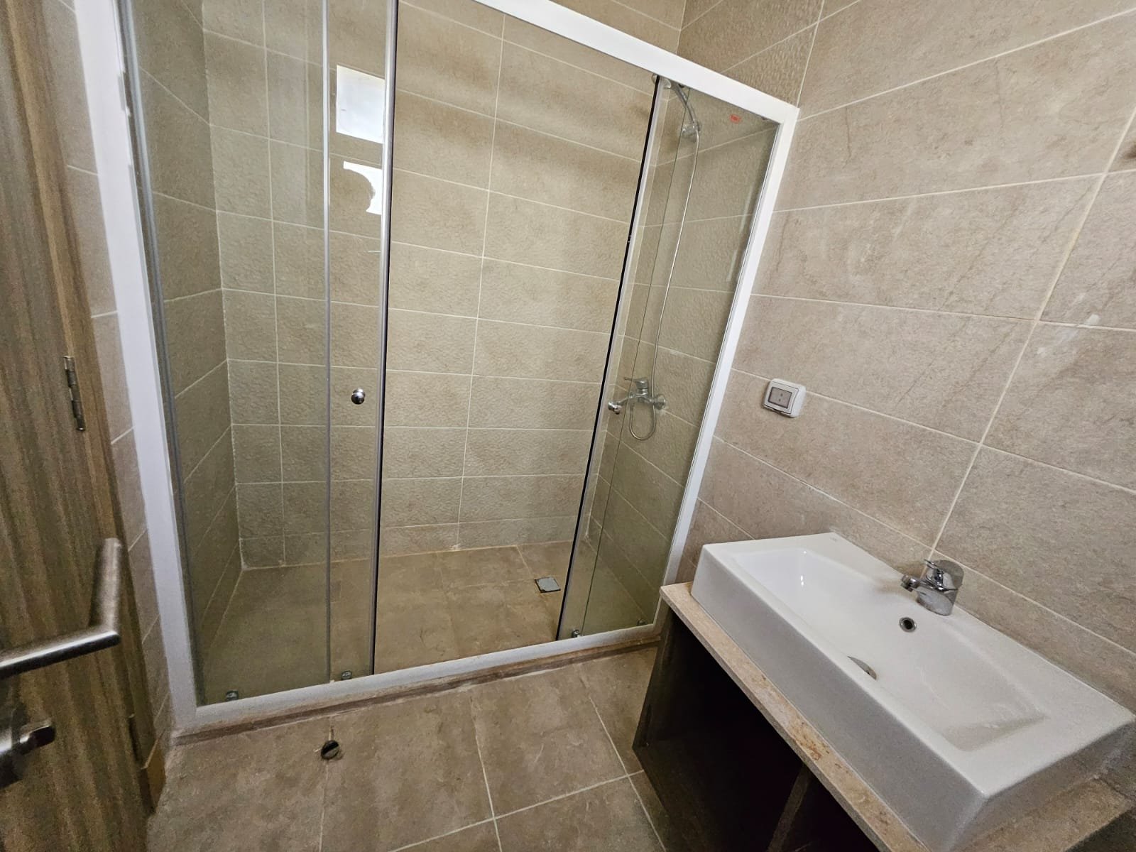Bathroom with glass shower and washbasin - sky loft in Moon Residence, Fifth Square, New Cairo