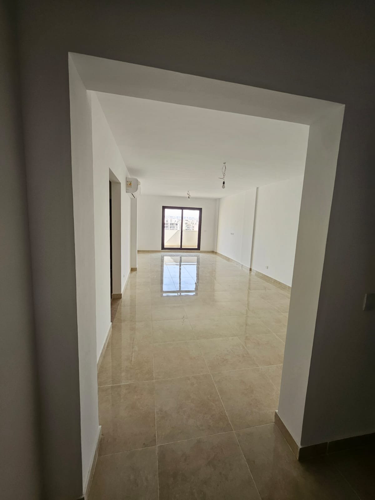 Entrance to an empty living room - sky loft in Moon Residence, Fifth Square, New Cairo
