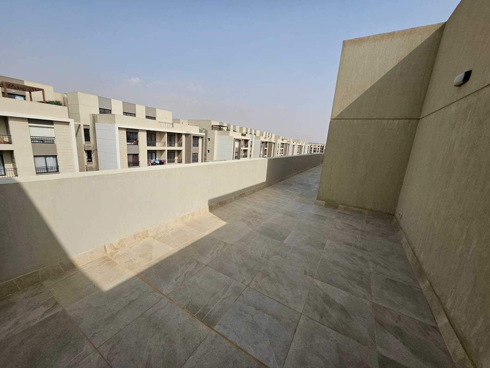 Roof terrace with compound view - sky loft in Moon Residence, Fifth Square, New Cairo