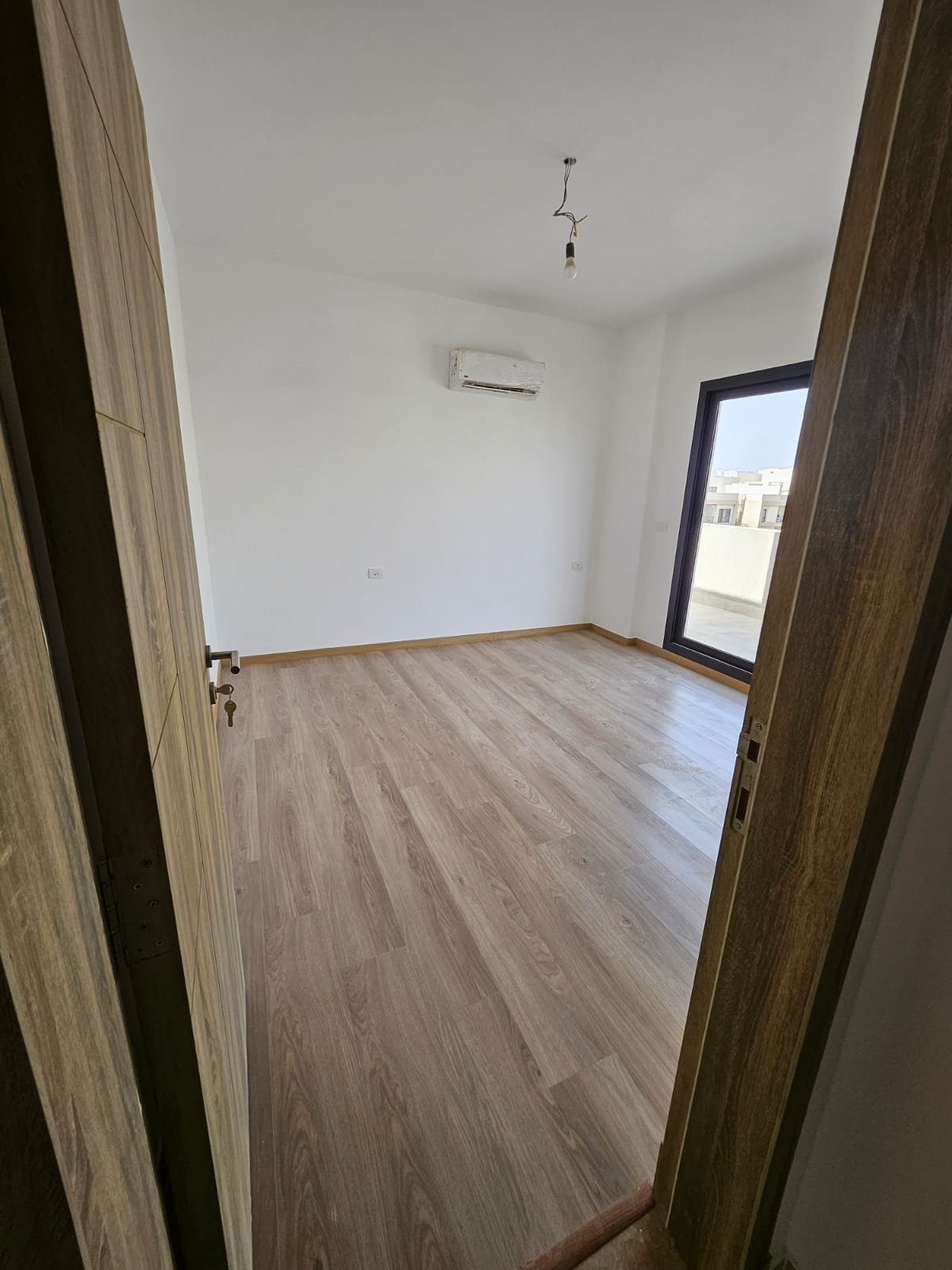 Empty bedroom with balcony window - sky loft in Moon Residence, Fifth Square, New Cairo