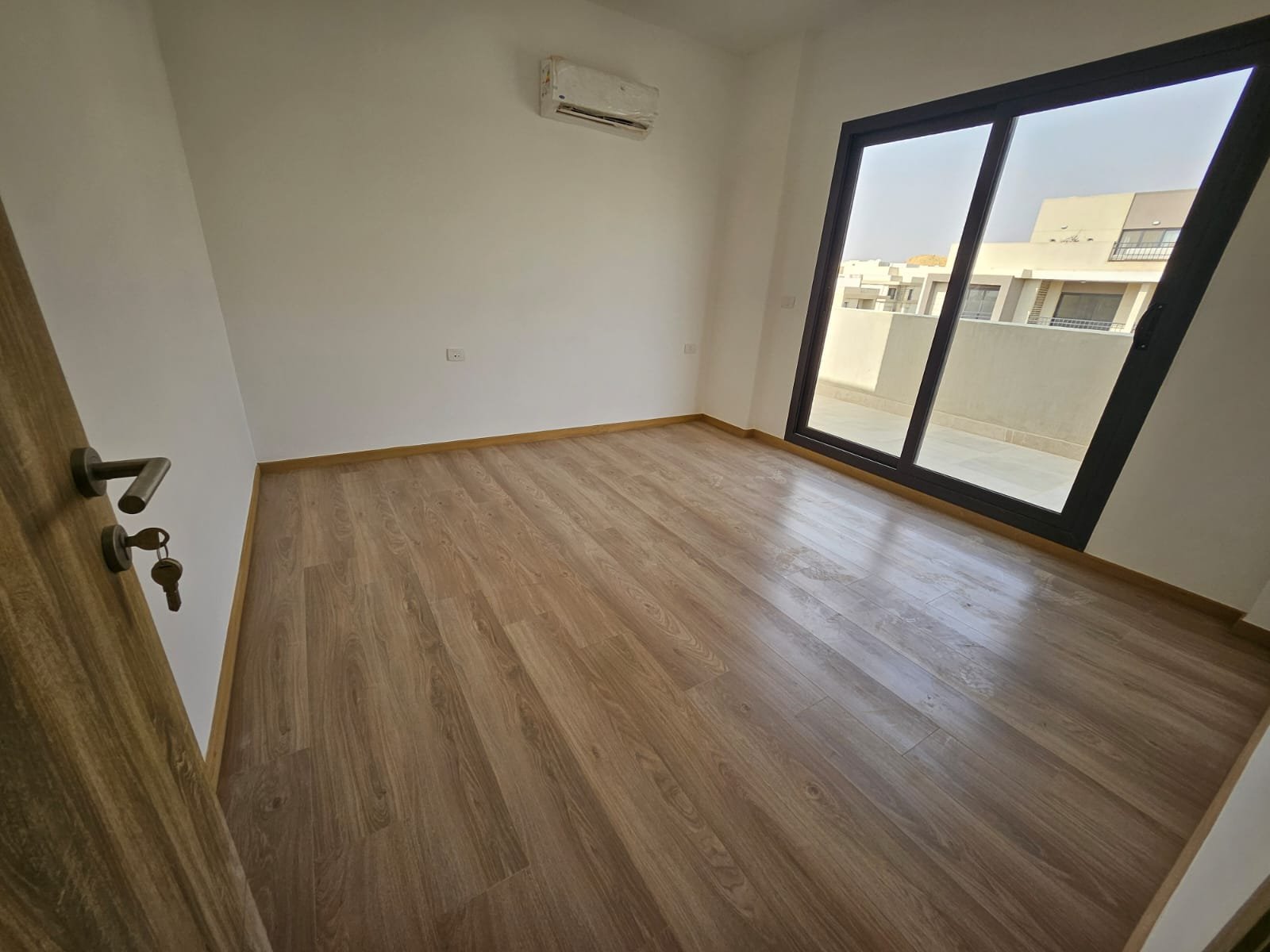 Empty bedroom with large balcony door - sky loft in Moon Residence, Fifth Square, New Cairo