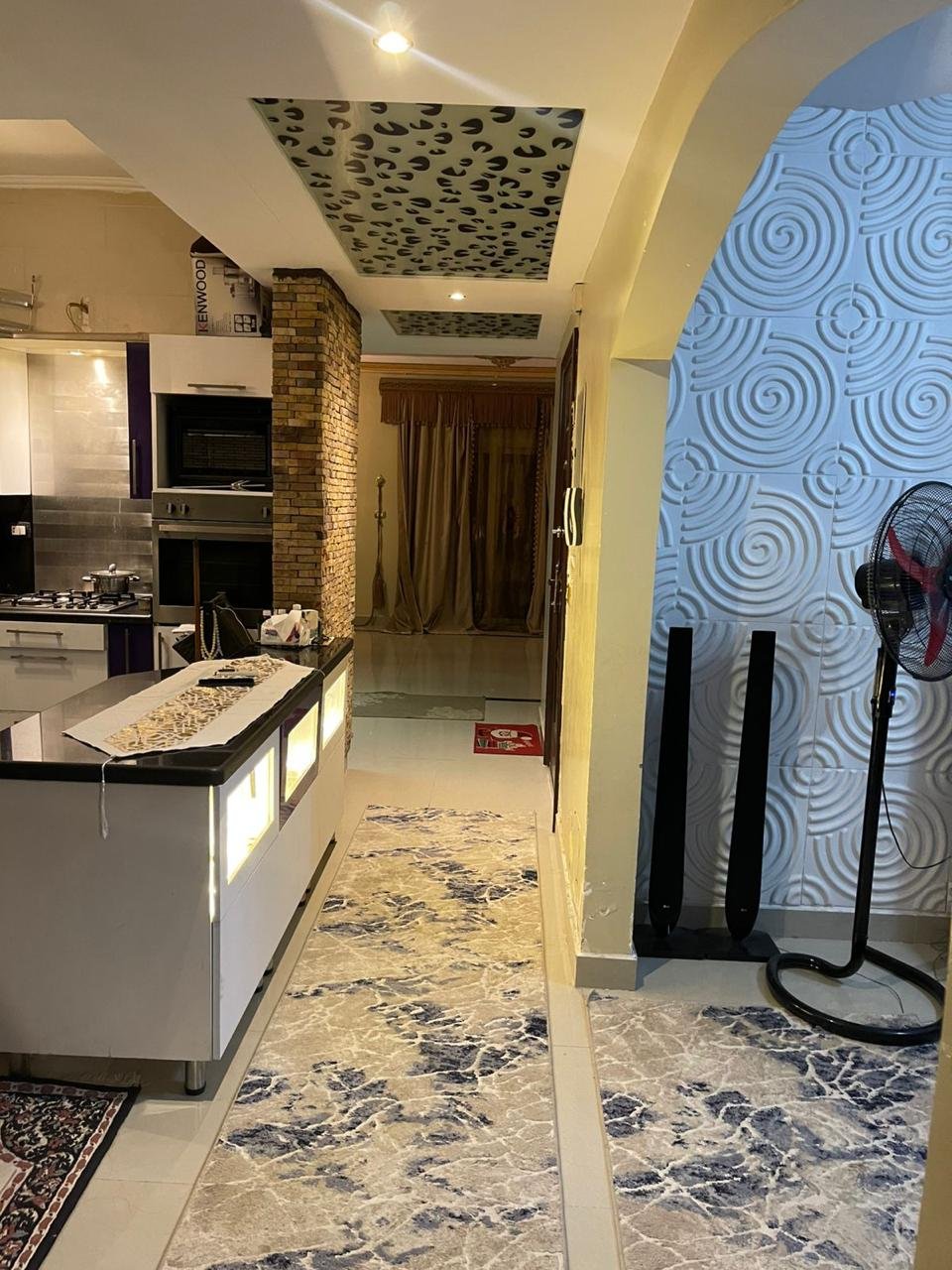 mostasharin-apt-221-ph2 Open kitchen and a patterned hallway rug with a wallpaper accent wall - apartment in South Investors 2, 5th Settlement
