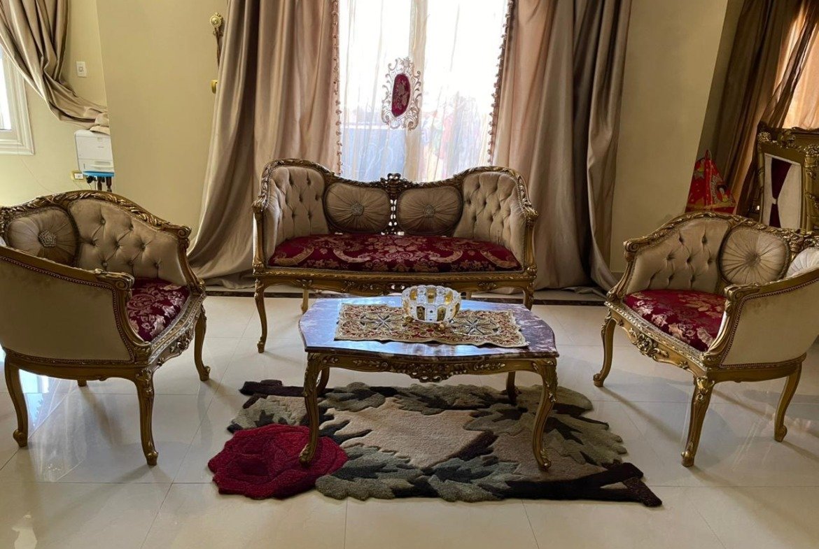 Gilded living room set with burgundy cushions and a coffee table - apartment in South Investors 2, 5th Settlement