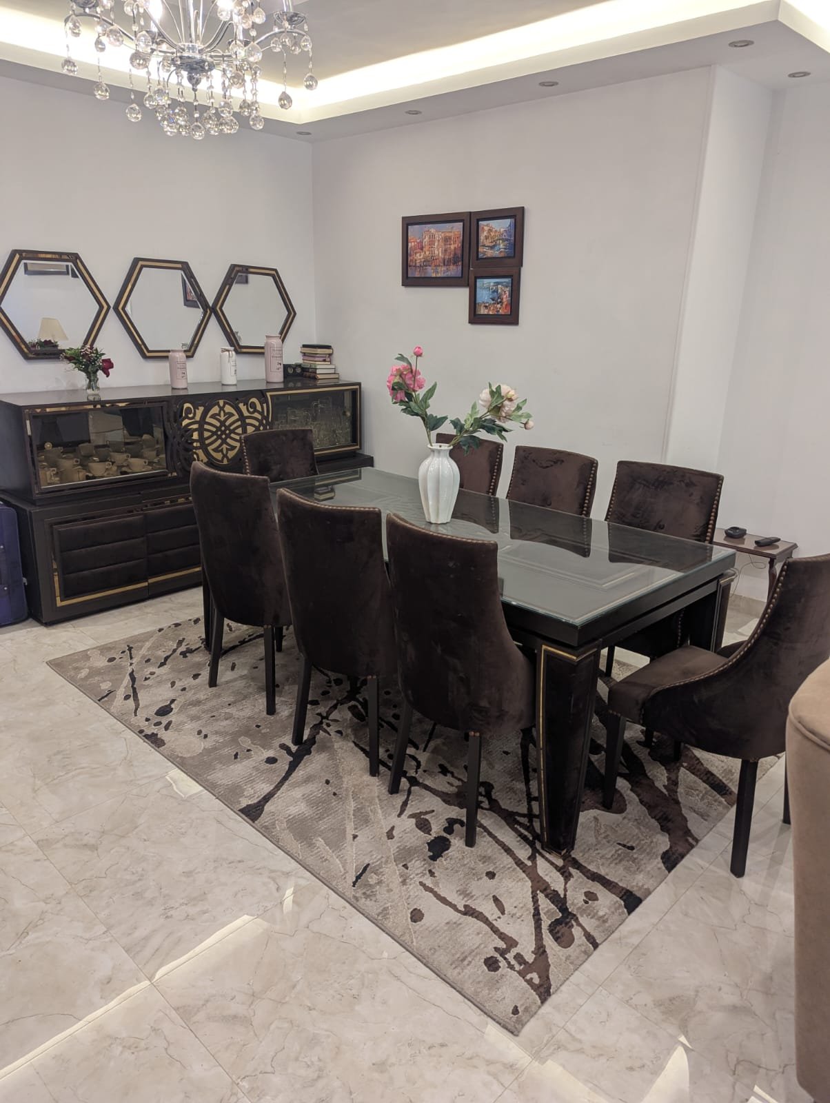 Dining table with dark chairs and a patterned rug - villa in Mountain View Hyde Park, New Cairo