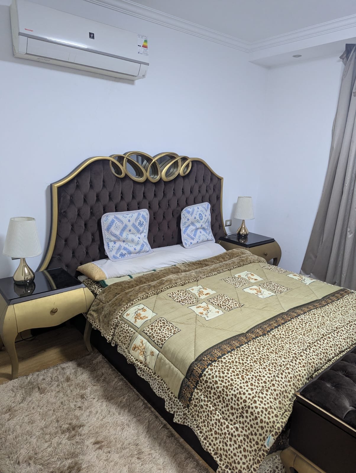 Bedroom with an upholstered headboard and leopard-print cover - villa in Mountain View Hyde Park, New Cairo