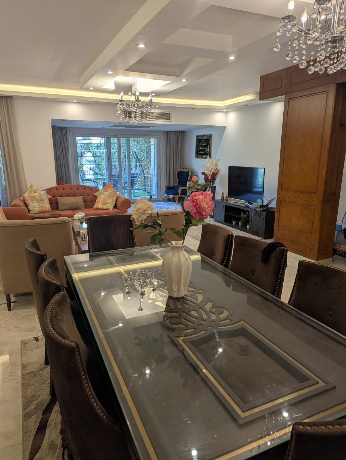 Glass-top dining table in a ground-floor living space - villa in Mountain View Hyde Park, New Cairo